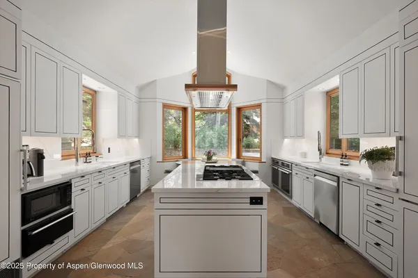 a kitchen with white cabinets and white appliances