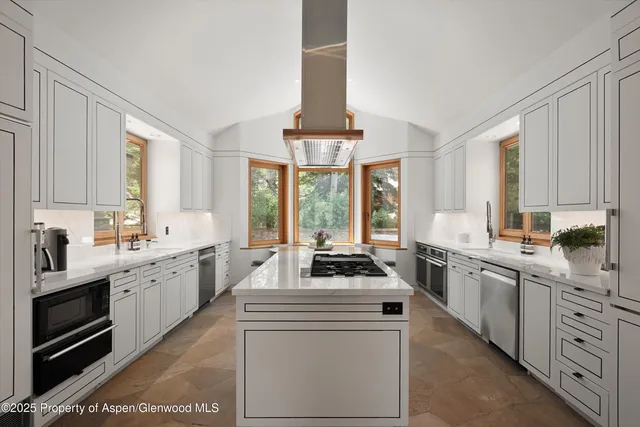 a kitchen with white cabinets and white appliances
