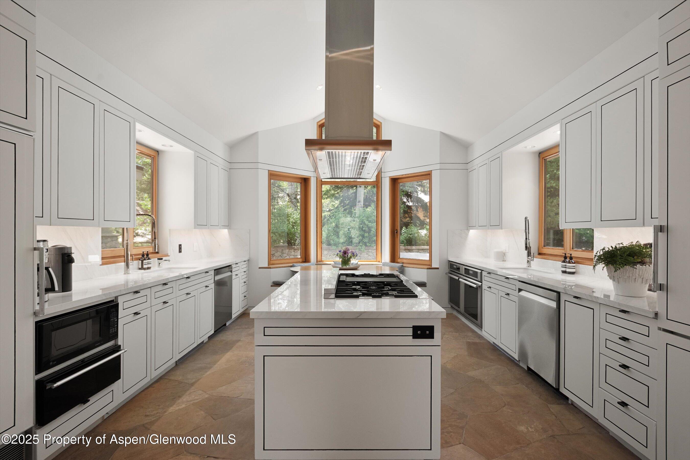 800 Roaring Fork Road Aspen, CO 81611 - Photo 10 of 37 a kitchen with white cabinets and white appliances