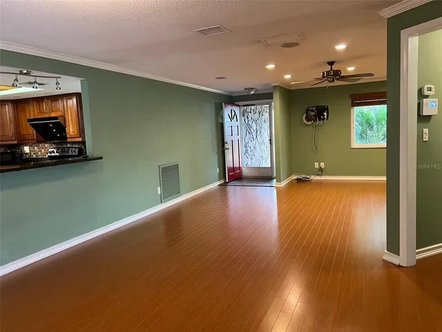 a view of a room with wooden floor and window