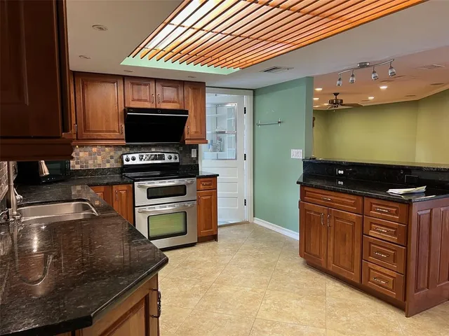 a kitchen with a stove and a microwave