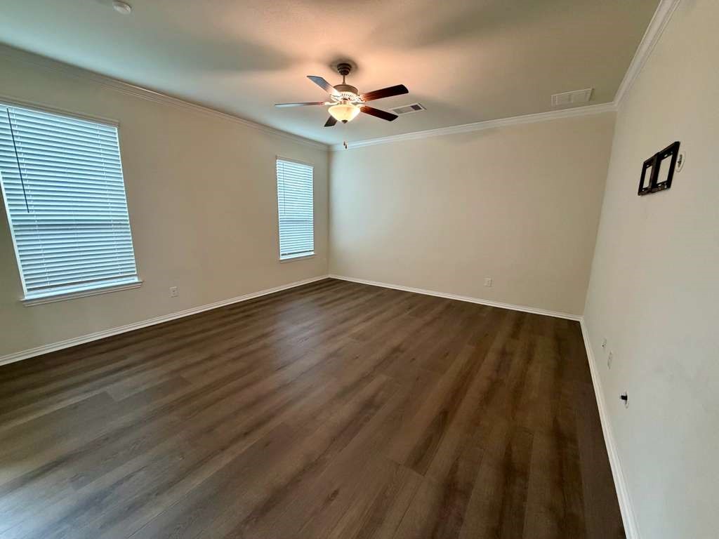 28614 Oakmist Point Lane Katy, TX 77494 - Photo 14 of 42 a view of an empty room with wooden floor and a ceiling fan