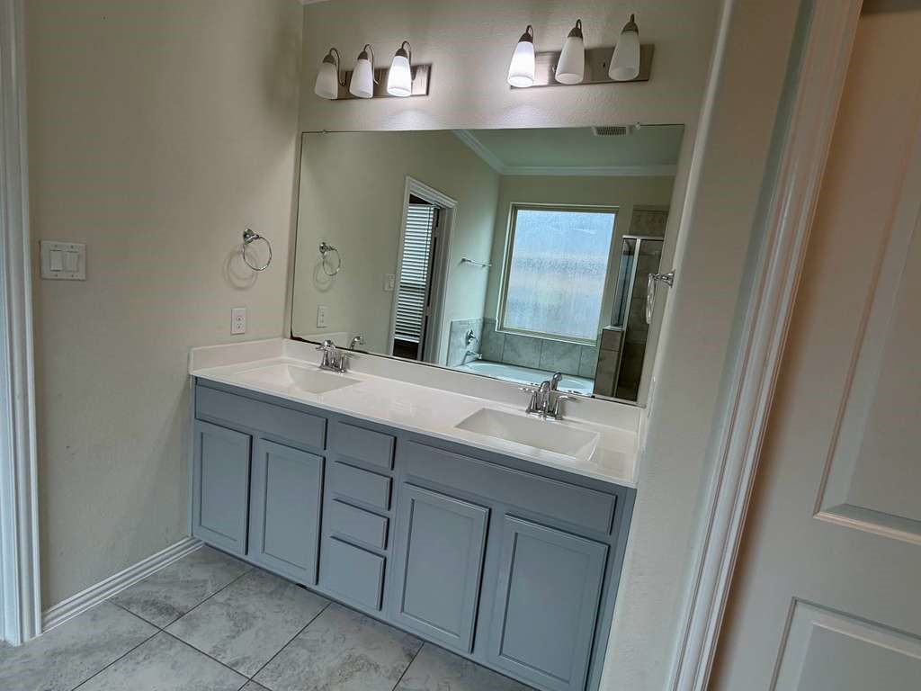 28614 Oakmist Point Lane Katy, TX 77494 - Photo 16 of 42 a bathroom with a double vanity sink and a mirror