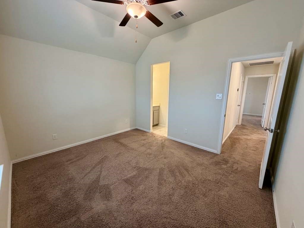 28614 Oakmist Point Lane Katy, TX 77494 - Photo 35 of 42 an empty room with a chandelier fan and windows