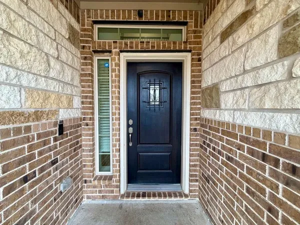 a hallway with a black white checkered floor and a livingroom