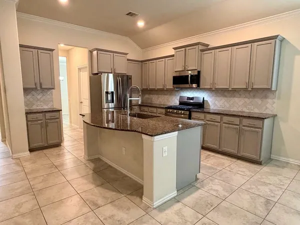 a kitchen with a sink a counter space and cabinets