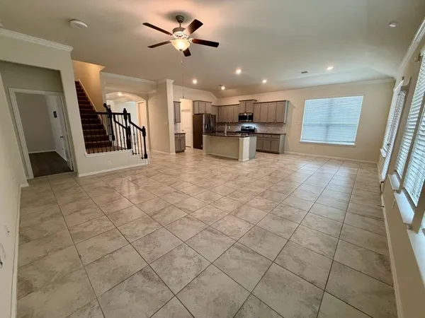 a view of a kitchen with furniture and a refrigerator