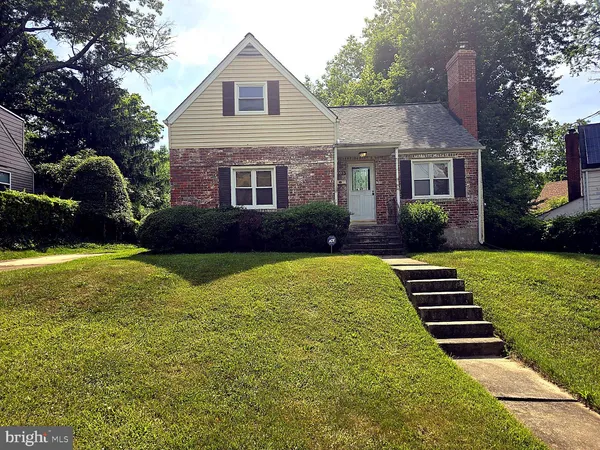 a kitchen with stainless steel appliances granite countertop a refrigerator a stove and a sink with wooden floor
