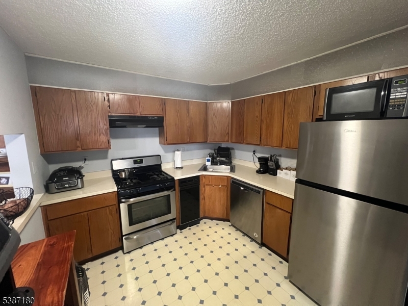 292 English Place Bernards, NJ 07920 - Photo 4 of 10 a kitchen with a refrigerator sink and stove