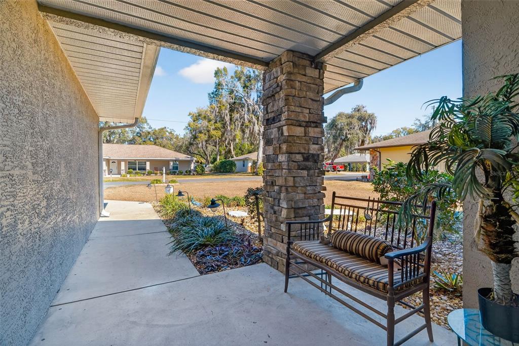 115 Hunting Lodge Drive Inverness, FL 34453 - Photo 11 of 59 a view of a porch with furniture and a yard