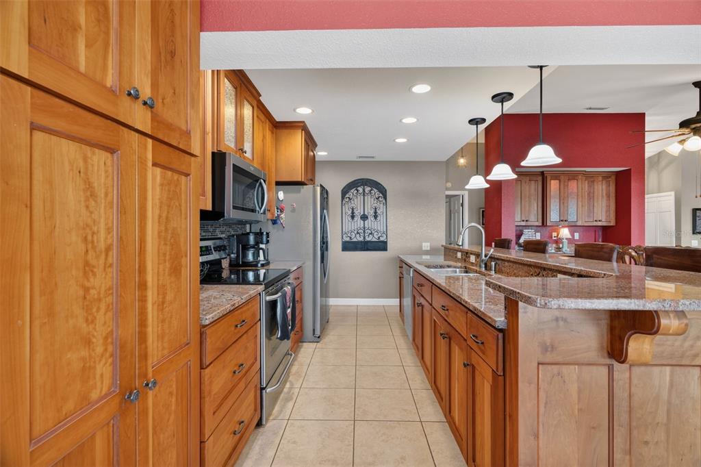 115 Hunting Lodge Drive Inverness, FL 34453 - Photo 14 of 59 a kitchen with stainless steel appliances granite countertop a sink and cabinets