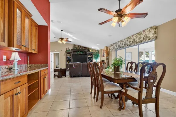 a dining room with furniture a chandelier and wooden floor