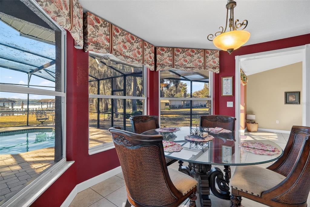 115 Hunting Lodge Drive Inverness, FL 34453 - Photo 20 of 59 a dining room with furniture a chandelier and wooden floor