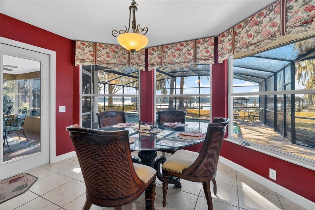 115 Hunting Lodge Drive Inverness, FL 34453 - Photo 21 of 59 a view of a dining room with furniture a chandelier and wooden floor