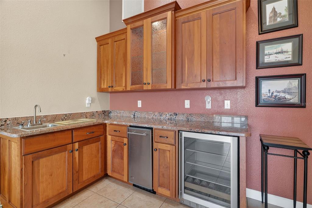 115 Hunting Lodge Drive Inverness, FL 34453 - Photo 24 of 59 a kitchen with granite countertop a sink and cabinets
