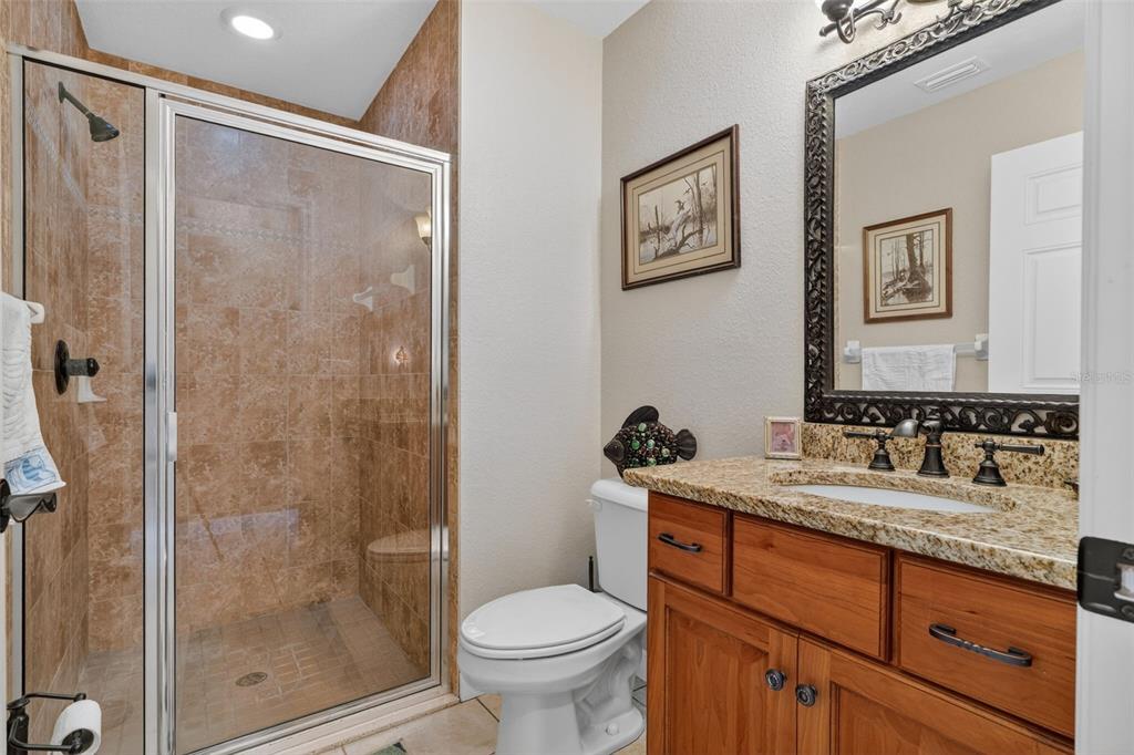 115 Hunting Lodge Drive Inverness, FL 34453 - Photo 26 of 59 a bathroom with a granite countertop sink toilet and shower