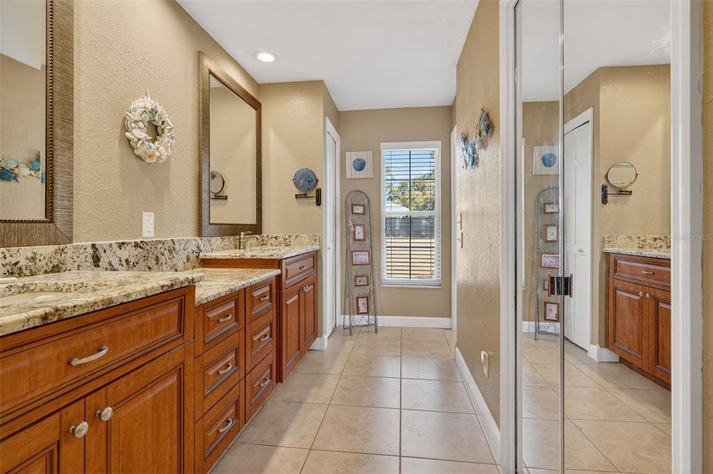 115 Hunting Lodge Drive Inverness, FL 34453 - Photo 32 of 59 a spacious bathroom with a granite countertop sink mirror and a shower