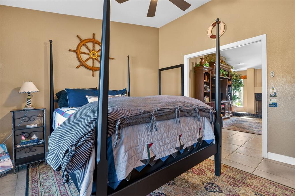 115 Hunting Lodge Drive Inverness, FL 34453 - Photo 35 of 59 a spacious bedroom with a bed a dresser and potted plants