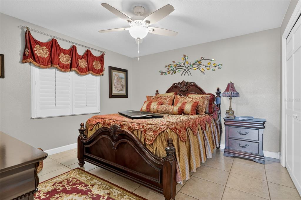 115 Hunting Lodge Drive Inverness, FL 34453 - Photo 37 of 59 a bedroom with a bed and a chandelier