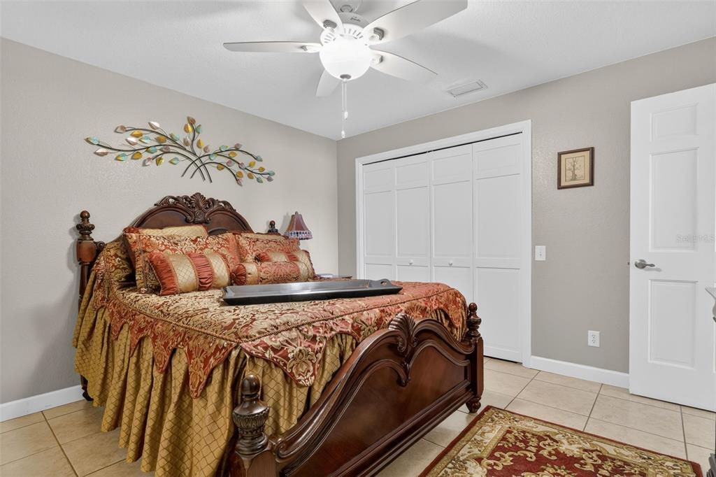 115 Hunting Lodge Drive Inverness, FL 34453 - Photo 38 of 59 a bedroom with a bed and a chandelier