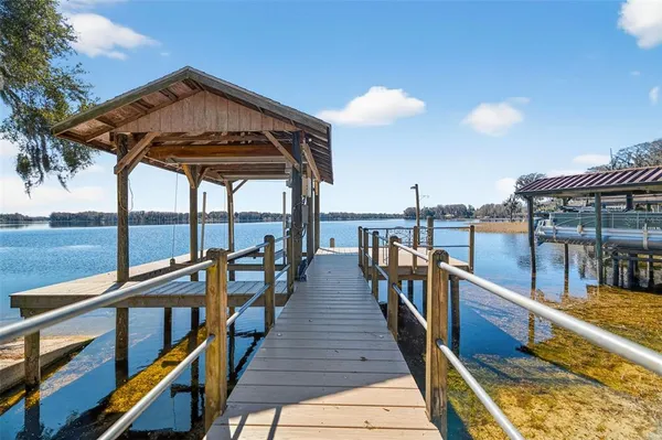 a view of a balcony with wooden floor and outdoor seating