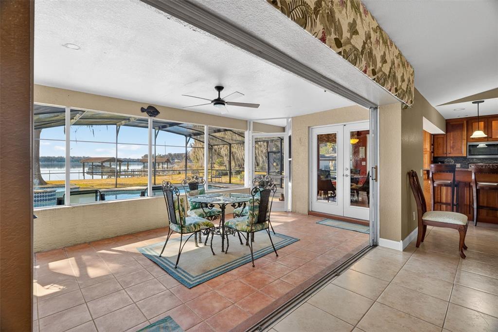 115 Hunting Lodge Drive Inverness, FL 34453 - Photo 43 of 59 a dining room with furniture and a floor to ceiling window