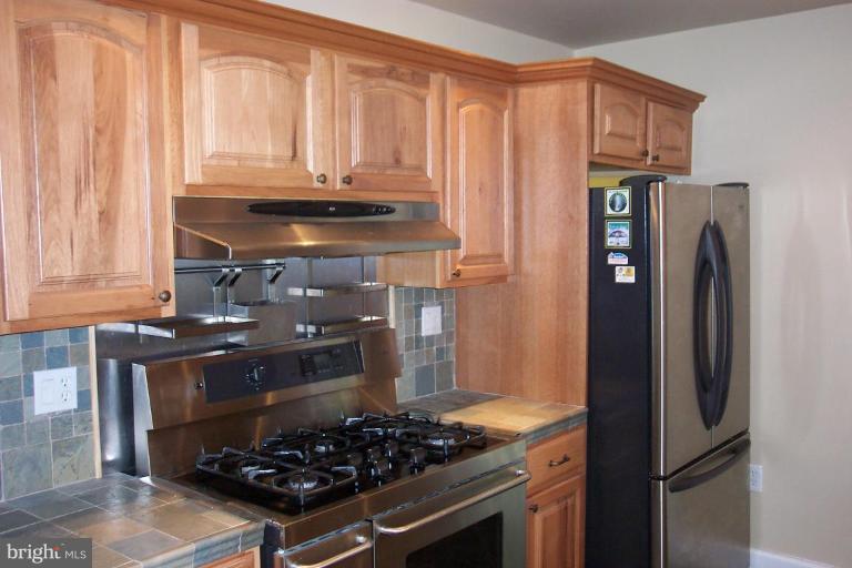 7114 York Road Baltimore, MD 21212 - Photo 11 of 15 a kitchen with stainless steel appliances granite countertop a stove and a refrigerator