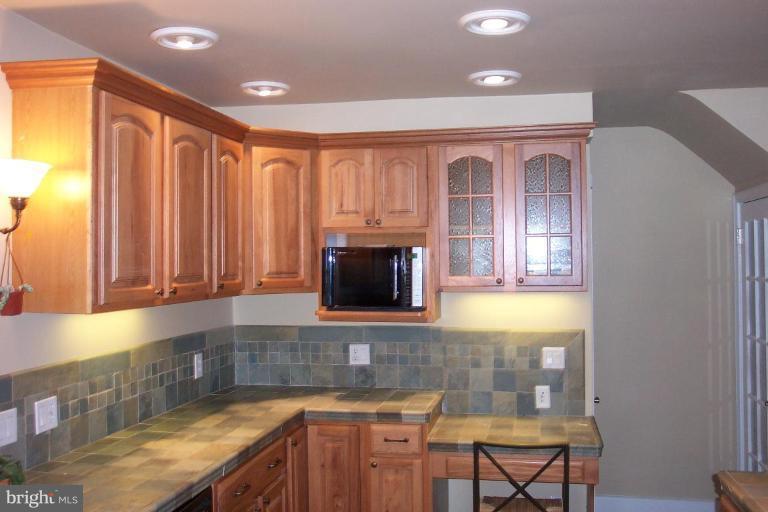 7114 York Road Baltimore, MD 21212 - Photo 12 of 15 a kitchen with granite countertop a sink cabinets and window