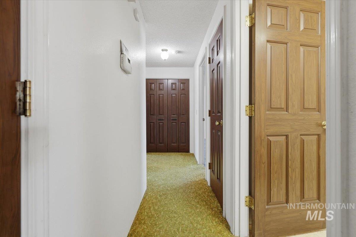 1311 North Middleton Road Nampa, ID 83651 - Photo 20 of 49 Hallway featuring light green carpet and white walls