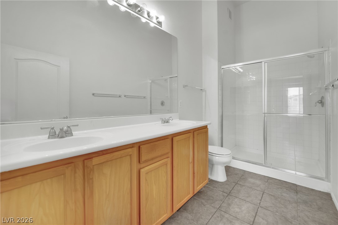 2305 West Horizon Ridge Parkway, Unit 2722 Henderson, NV 89052 - Photo 12 of 23 Full bathroom featuring double vanity, a stall shower, and light tile patterned flooring