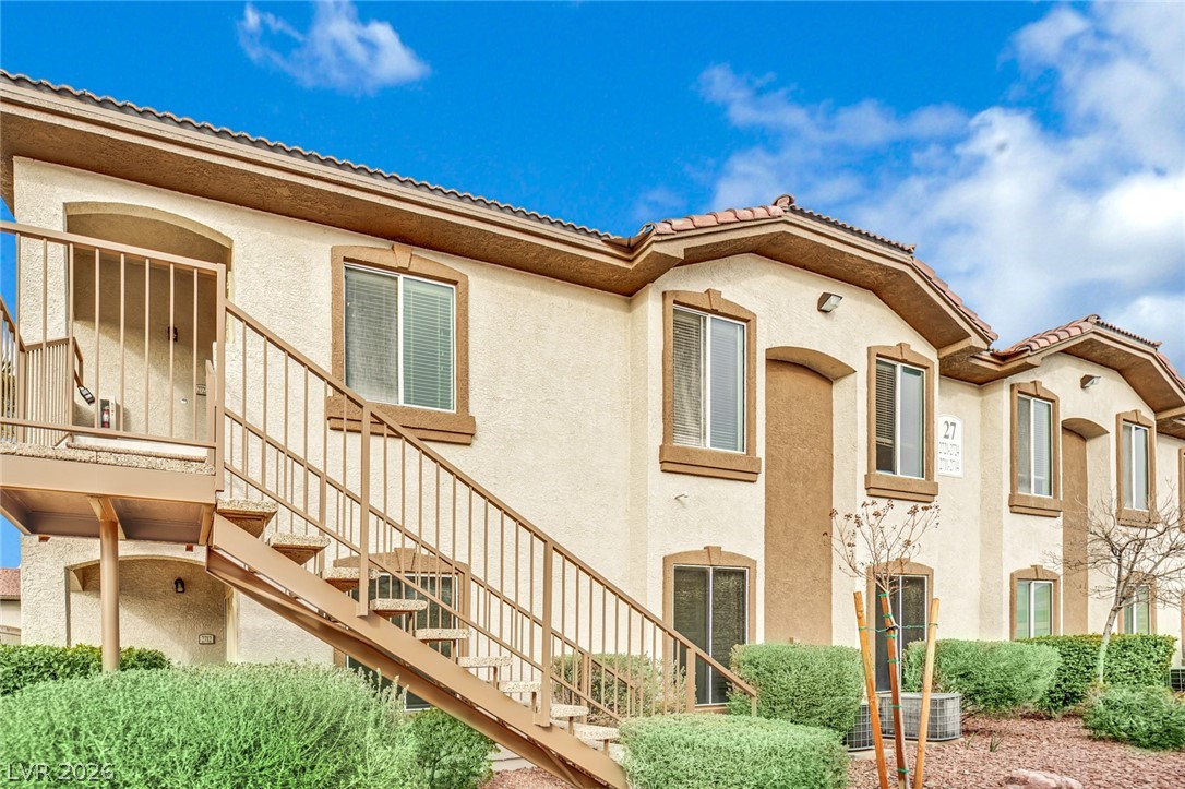 2305 West Horizon Ridge Parkway, Unit 2722 Henderson, NV 89052 - Photo 20 of 23 View of side of home with stucco siding and a tile roof