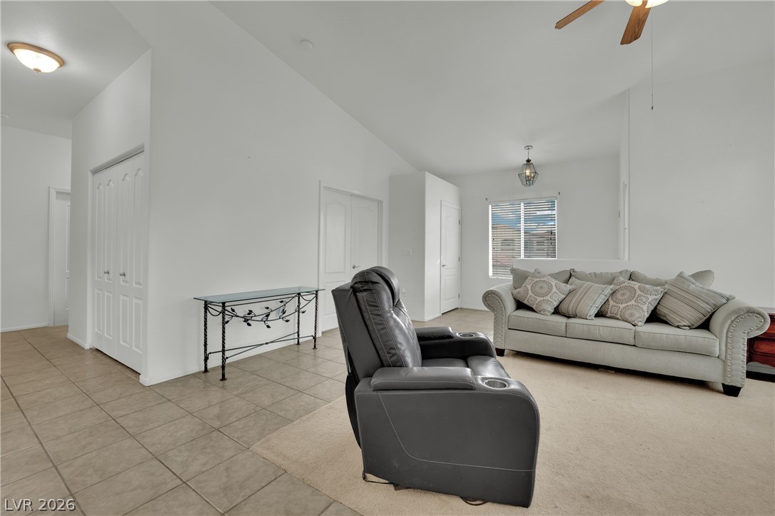 2305 West Horizon Ridge Parkway, Unit 2722 Henderson, NV 89052 - Photo 4 of 23 Living room featuring light tile patterned floors, ceiling fan, and vaulted ceiling