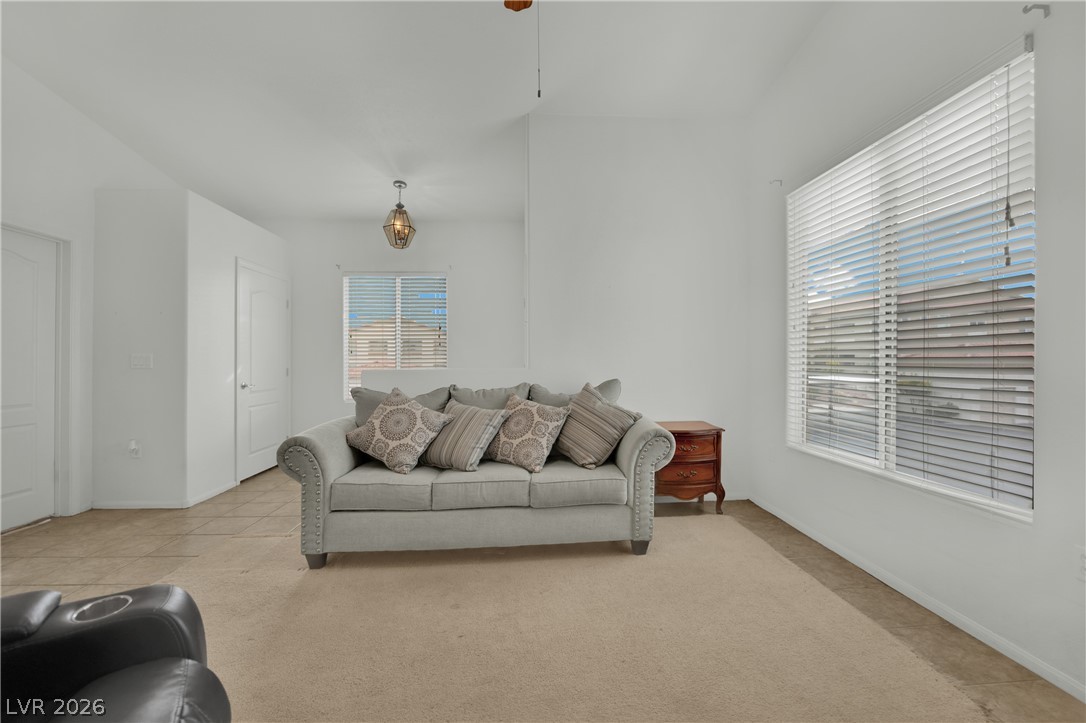 2305 West Horizon Ridge Parkway, Unit 2722 Henderson, NV 89052 - Photo 5 of 23 Living area with light colored carpet and a ceiling fan