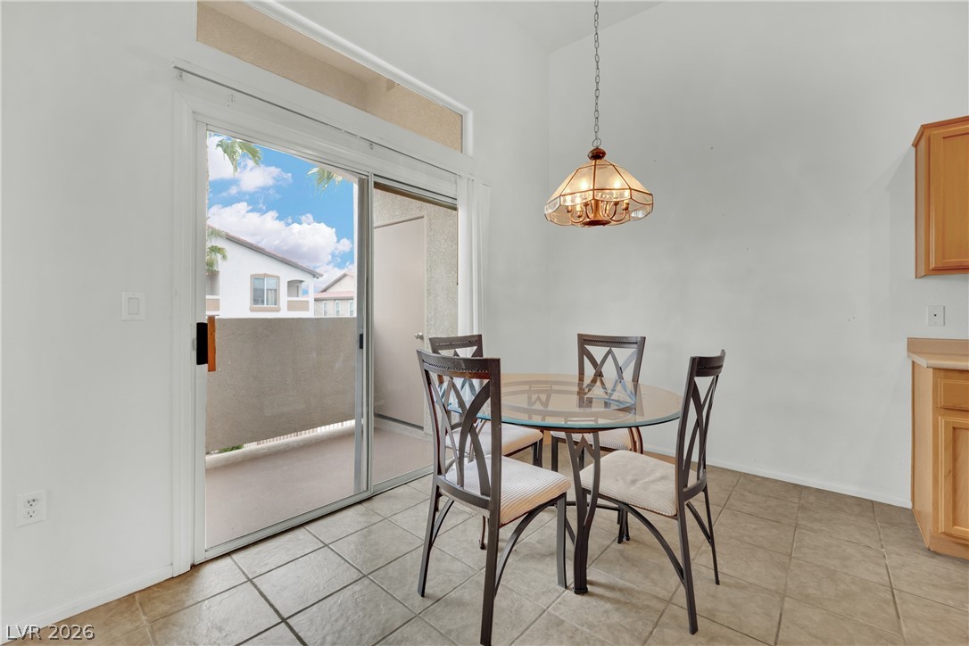 2305 West Horizon Ridge Parkway, Unit 2722 Henderson, NV 89052 - Photo 8 of 23 Dining area featuring light tile patterned floors and lofted ceiling