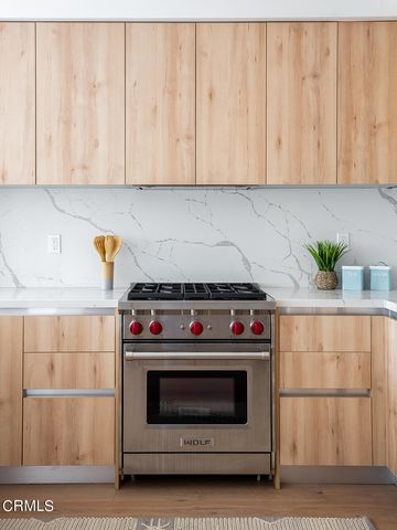 a stove top oven sitting inside of a kitchen