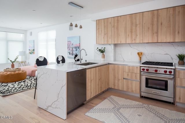 a kitchen with a sink stove and cabinets
