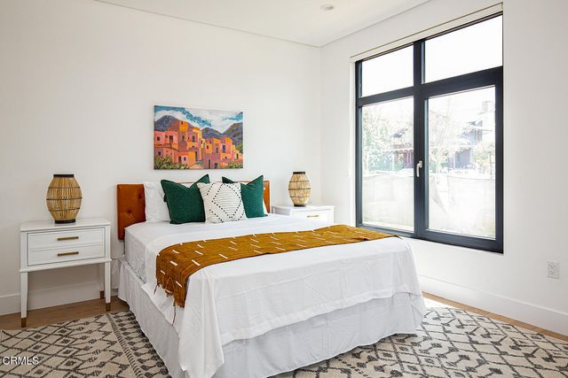 a bedroom with a bed and a window