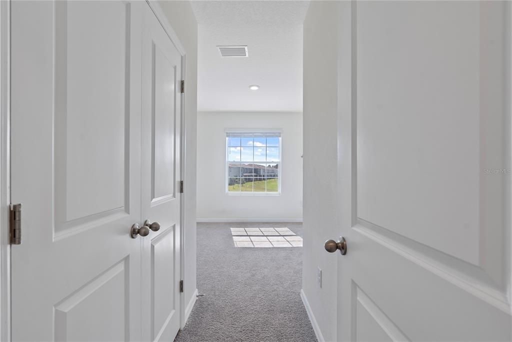 32395 Turtle Grace Loop Wesley Chapel, FL 33545 - Photo 17 of 39 a view of a hallway with windows