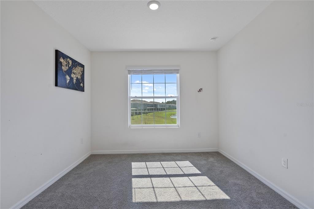 32395 Turtle Grace Loop Wesley Chapel, FL 33545 - Photo 18 of 39 an empty room with a window