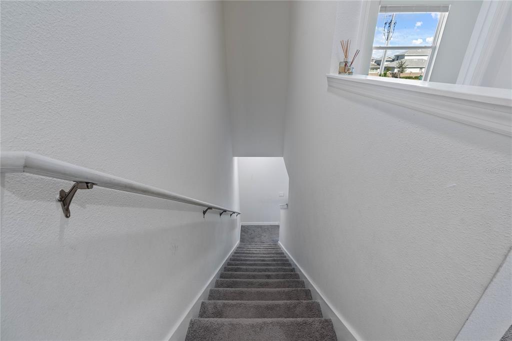 32395 Turtle Grace Loop Wesley Chapel, FL 33545 - Photo 21 of 39 a view of entryway and hall with wooden floor