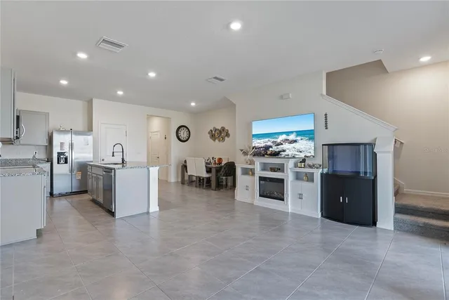a large white kitchen with a stove top oven and cabinets