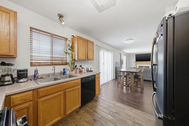 a kitchen with stainless steel appliances granite countertop sink stove top oven and cabinets
