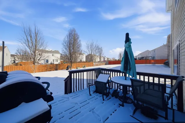 a view of a deck with wooden floor and outdoor seating