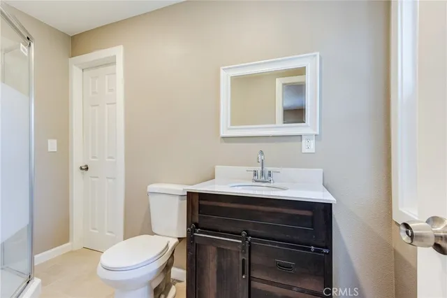 a white toilet sitting next to a bathroom sink