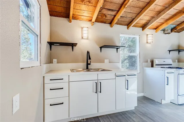 a kitchen with stainless steel appliances granite countertop a refrigerator and a stove