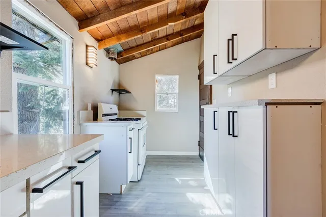 a kitchen with a stove a sink and a microwave