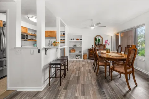 a view of a dining room with furniture and wooden floor