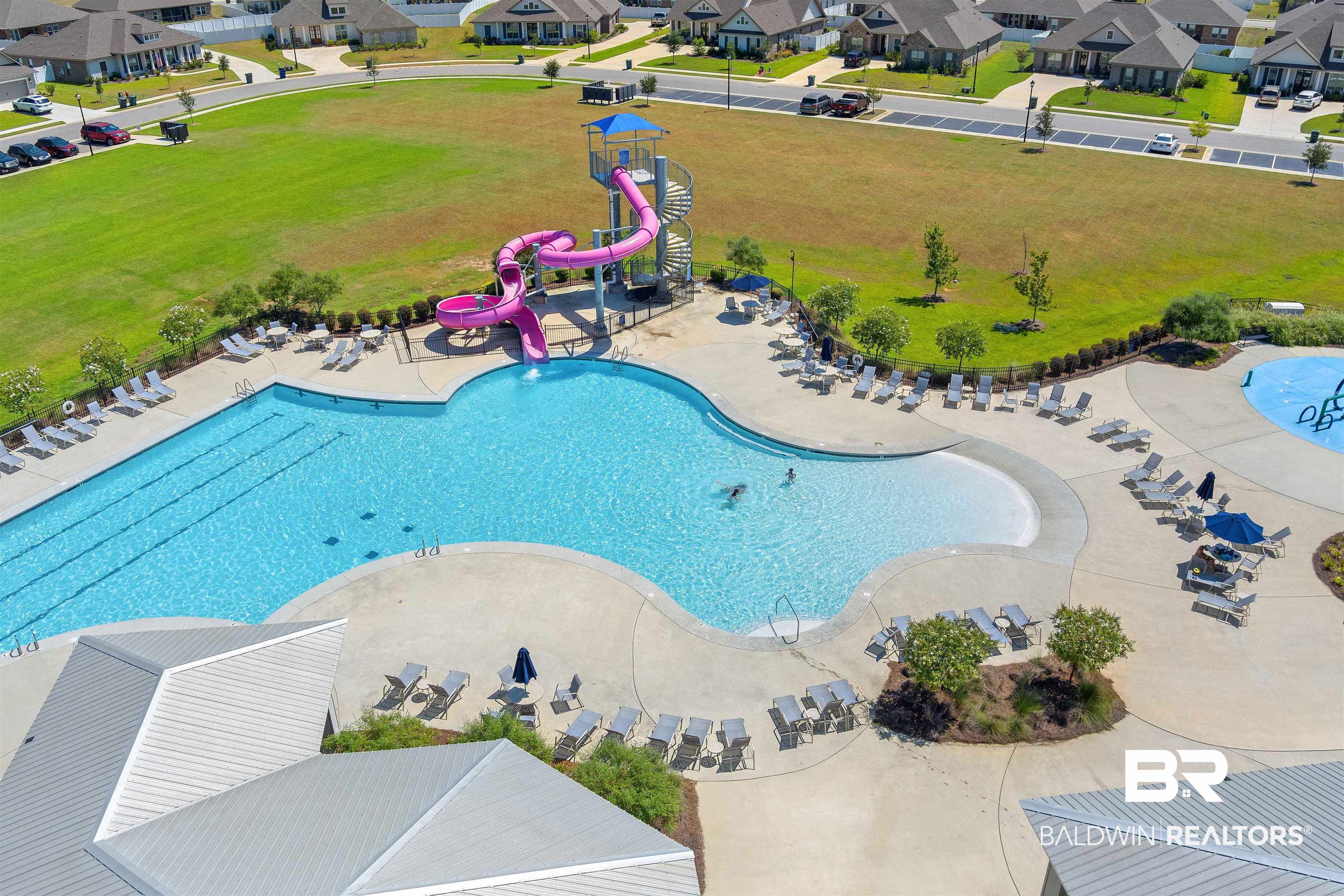 24341 Alydar Loop Daphne, AL 36526 - Photo 41 of 45 Community pool featuring a water slide, a residential view, and a yard