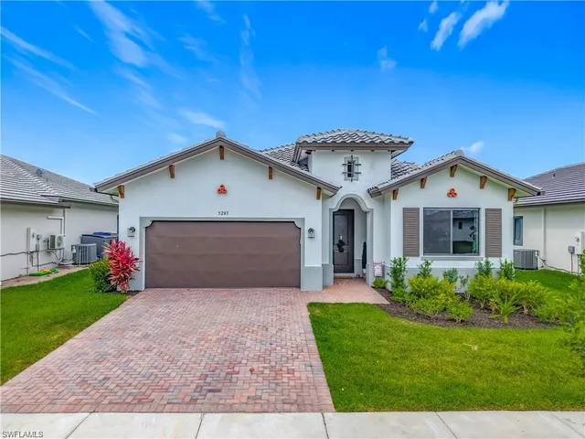 a front view of house with yard and garage
