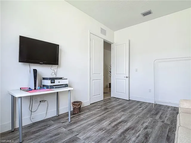 a bathroom with a granite countertop sink a toilet and a mirror